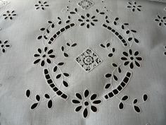 an embroidered tablecloth with black and white designs