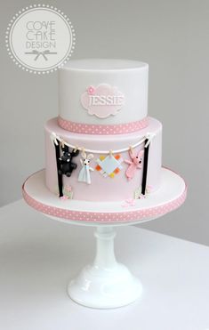 a three tiered cake decorated with clothes and bunting