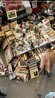 a man is looking at an assortment of items on the ground in front of him