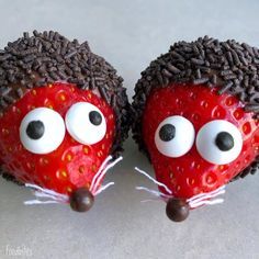 two chocolate covered strawberries with googly eyes