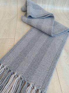 It's a lovely winter scarf for men. I weaved this gray scarf on my traditional weaving loom. This mens wool scarf can be an amazing new years gift or christmas t for your dad or your husband. It's both elegant and smart. It's warm and light scarf as well as stylish. This handwoven scarf is extra long so it can be easily be wrapped two times around. The wool and acrylic blend scarf is very pleasant to touch and will keep you warm during the winter season. This men winter scarf can be worn with anything from a smart dress to jeans. This blue wool scarf has a wonderful color combination of light and dark gray. It's a perfect winter and christmas gift for the person who likes handwoven scarves. This blue winter scarf was woven on my weaving loom like my whole scarves. It's suitable for both me Men Christmas Gift, Scarf For Men, Handwoven Scarf, Weaving Loom, Smart Dress, Grey Scarf, Traditional Weaving, Scarf Men, Loom Weaving