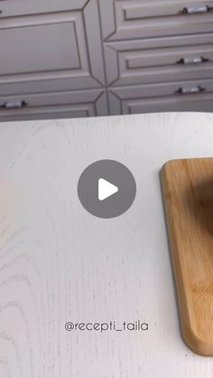 a wooden cutting board sitting on top of a counter