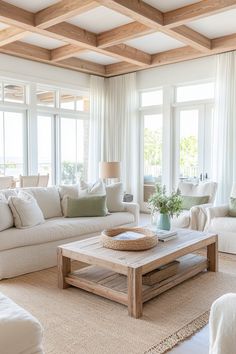 a living room filled with white furniture and lots of windows