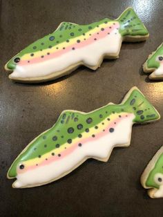 four decorated cookies in the shape of fish