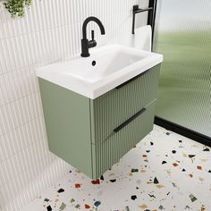 a bathroom sink sitting next to a green cabinet