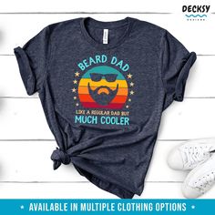 Be the coolest dad around with this "Bearded Dad" shirt! This funny tee features a comfy design with a witty saying that's sure to bring a smile. Show off your cool style with this must-have shirt! BEARD DAD LIKE A REGULAR DAD BUT MUCH COOLER ★ T SHIRT, TANK TOP, SWEATSHIRT, HOODIE ★ Casual Tops With Funny Print For Father's Day, Father's Day Casual Slogan Tops, Cool Relaxed Fit T-shirt With Funny Print, Father's Day T-shirt With Funny Print In Relaxed Fit, Funny Husband, Papa Shirts, Funny Dad Shirts, Husband Humor, Funny Tees