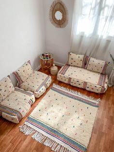 a living room with couches and rugs on the floor