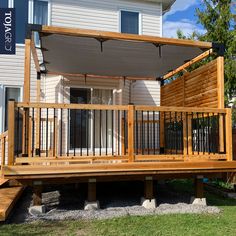 a wooden deck with an awning over it