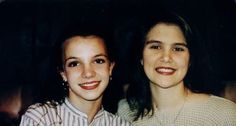 two women standing next to each other smiling