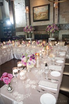 an image of a table set up with flowers and candles for a wedding or special event