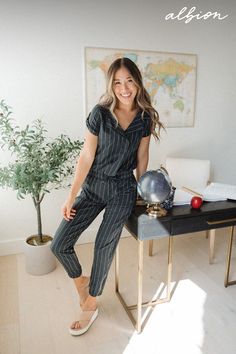 A classy collar, timeless navy stripe print, and button details make this jumpsuit a great fit for office attire, going out, and traveling in sophisticated comfort. Chic Striped Jumpsuits And Rompers For Work, Albion Fit Swim, Albion Fit Swimsuit, Pinstripe Jumpsuit, Albion Fit, Collar Jumpsuit, Maternity Swimsuit, Office Attire, Swim Skirt