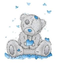 a white teddy bear sitting on the ground with blue hearts around it's eyes