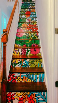 a stair case painted with colorful flowers and leaves