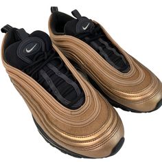 These Nike Air Max 97 Sneakers Feature A Bronze And Black Colorway, Providing Both Style And Comfort. Ideal For Casual And Athletic Wear. Lace-Up Closure Cushioned Air-Sole Unit Pull Tabs On Heel Durable Rubber Outsole Made In Vietnam Features: Sneaker Size: Womens 10 Condition: Pre-Owned Great Shape! Minor Scuffs And Light Wear, Nothing Heavy, Looks Good, Clean And Ready To Wear. Highly Rated Seller- Fast Shipper Nike Gold Sneakers For Streetwear, Gold Sports Sneakers With Laces, Nike Gold Sneakers With Boost Midsole, Nike Gold Sporty Sneakers, Gold Sporty Running Sneakers, Gold Low-top Running Sneakers, Gold Sneakers With Air Cushioning For Sports, Nike Gold Casual Sneakers, Nike Casual Gold Sneakers