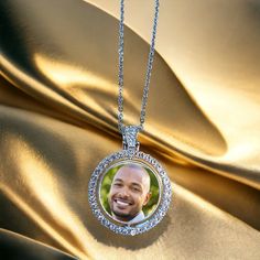 Introducing our stunning round silver photo necklace with rhinestones! This necklace is a perfect way to keep your loved ones close to your heart.  What makes this necklace unique is its spinning feature, allowing you to display two photos at once!  You can easily switch between two photos by spinning the round pendant, which rotates smoothly to show each photo on each side. You can customize this necklace with your favorite photos, making it a thoughtful and personalized gift for yourself or so Silver Rhinestone Round Pendant Jewelry, Personalized Diamond White Jewelry, Personalized Round Diamond White Jewelry, Round Necklaces For Anniversary, White Gold Necklace With Bling And Round Pendant, Customizable Round Silver Locket Necklace, Round Rhinestone Jewelry For Anniversary, Circular Necklaces With Diamond Accents For Gifts, White Gold Bling Round Necklace