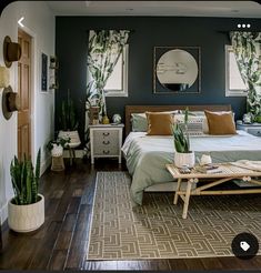 a bed room with a neatly made bed and green plants on the wall behind it