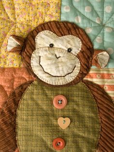 a close up of a stuffed animal on a quilt