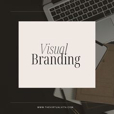 the words visual branding on top of a desk next to a laptop and other office supplies