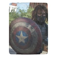 a man dressed as captain america holding a shield