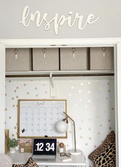 a white desk topped with a desktop computer next to a chair and wall mounted calendar