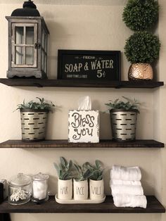 bathroom shelves decorated with plants, soap and other items for decor on top of them