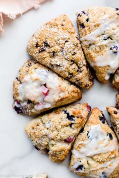 blueberry scones are arranged in a circle on a marble surface