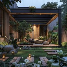 an outdoor living area is lit up with candles and greenery in the foreground