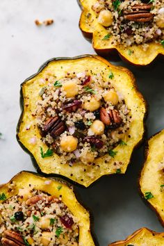 stuffed acorns filled with nuts and quinoa are on a white surface