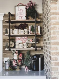 a shelf with coffee mugs and christmas decorations