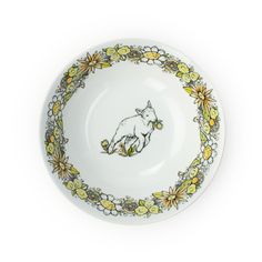 a white plate with yellow flowers and a cat on the side, in front of a white background