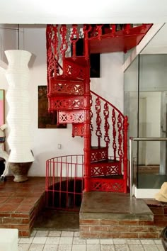 a red staircase in the middle of a living room