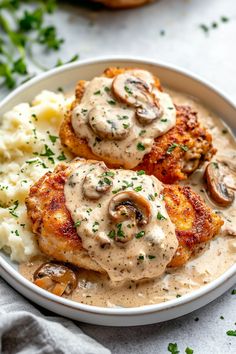 two meat patties covered in mushroom gravy and mashed potatoes