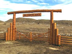 a wooden gate with a sign that says bare diamond ranch