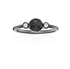 a black diamond ring with three diamonds on the side and one stone in the middle