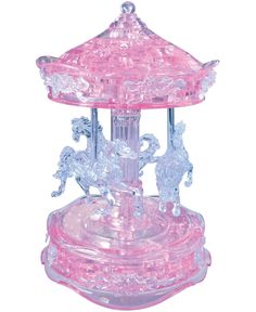 a pink glass carousel with horses on it