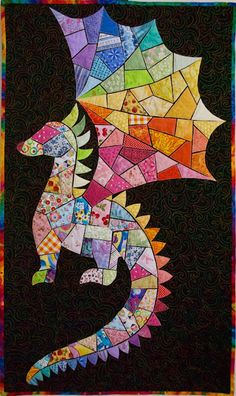 a colorful dragon made out of many different types of paper and threads on a black background