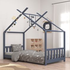 a child's bedroom with a blue bed frame and stars on the wall above it