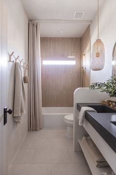 a bathroom with a sink, toilet and bathtub next to a window in it