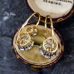 These dazzling platinum topped 18K yellow gold earrings are each accented with one (1) old European cut diamond set into an eight-prong platinum setting and one (1) old European cut diamond set into a four-prong platinum setting. The earrings measure 24.3mm X 10.9mm and are finished with 14K yellow gold lever style backs. They are simply perfect. Yellow Cushions, Yellow Gold Earrings, Cushion Cut Diamonds, European Cut Diamonds, Diamond Drops, Yellow Gold Earring, Diamond Set, Diamond Drop Earrings, Diamond Earrings Studs