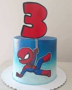 a spiderman birthday cake with the number three on it's top and bottom tier