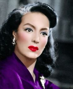 an old photo of a woman with dark hair and bright red lipstick on her lips