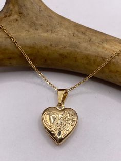 Vintage Gold Photo Locket is crafted in 9K Gold Filled, features a lovely, etched design and measures 1/2"x 1/2" (Without Bale)  Holds a tiny photo for wear as a dainty memory necklace.  We recommend using a laminated photo for longer lasting wear Delicate 9K GF gold chain available in lengths of 16, 18 ,20, 22" or 24" Thank you for supporting a small veteran owned business! All jewelry is shipped free within the US in a stylish gift box  PLEASE NOTE If we have multiples of the same vintage item Gold Heart-shaped Etched Jewelry, Gold Etched Heart Jewelry, Etched Heart Gold Jewelry, Etched Heart-shaped Gold Jewelry, Etched Heart-shaped Jewelry For Valentine's Day, Etched Heart Jewelry For Valentine's Day, Valentine's Day Etched Heart Jewelry, Vintage Gold Locket, Memorial Pendant