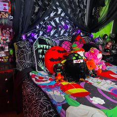 a bedroom decorated for halloween with decorations on the bed