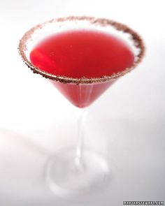 a red drink in a wine glass on a white background