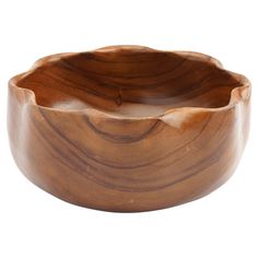 a wooden bowl sitting on top of a white surface