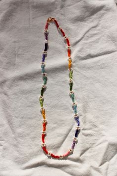 "Handmade Rainbow seed bead necklace. Trendy necklace, perfect for layering and beautiful to wear on its own as well. Makes a great gift and is perfect for friendship necklaces! Primary color refers to the color in the center of the Daisy. The \"Clear\" primary color is glow-in-the-dark. Multiple lengths and primary colors available.  The necklace shown in the photo measures just under 22 inches. For this particular necklace, altering the length of the necklace from clasp to end can be done, but Spiritual Multicolor Beaded Necklaces With Heart Beads, Spiritual Multicolor Heart Beads Necklace, Rainbow Letter Beads Necklace For Festivals, Rainbow Necklaces With Heart-shaped Beads, Bohemian Rainbow Beaded Necklace With Heart Beads, Bohemian Rainbow Necklace With Heart Beads, Bohemian Rainbow Beaded Necklaces With Heart Beads, Bohemian Rainbow Heart Beads Necklace, Rainbow Beaded Chain As A Gift