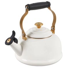 a white and gold tea kettle with a black handle