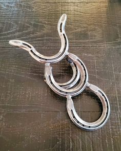 three metal rings sitting on top of a wooden table