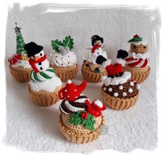 small knitted christmas cupcakes with snowmen on top