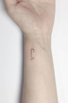 a person's arm with a small tattoo on the left side of their wrist